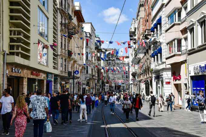 A city street with people walking and cars driving in Istanbul, Turkey.
