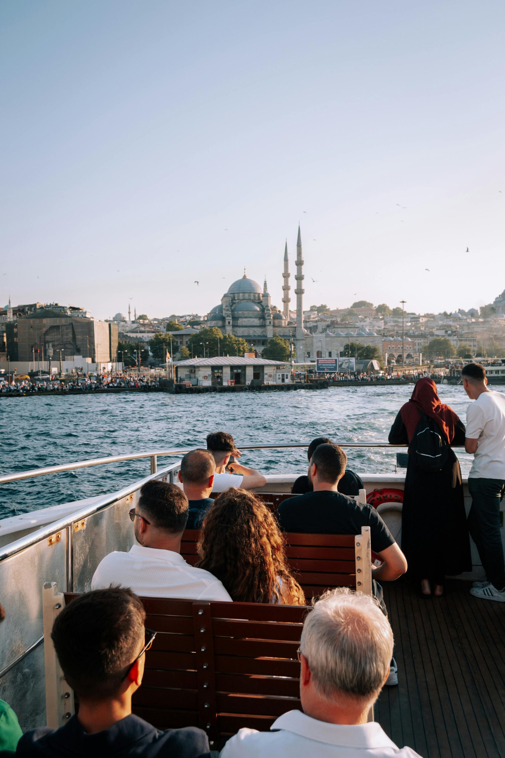 People on a boat cruising the Bosphorus Strait in Istanbul, Turkey.