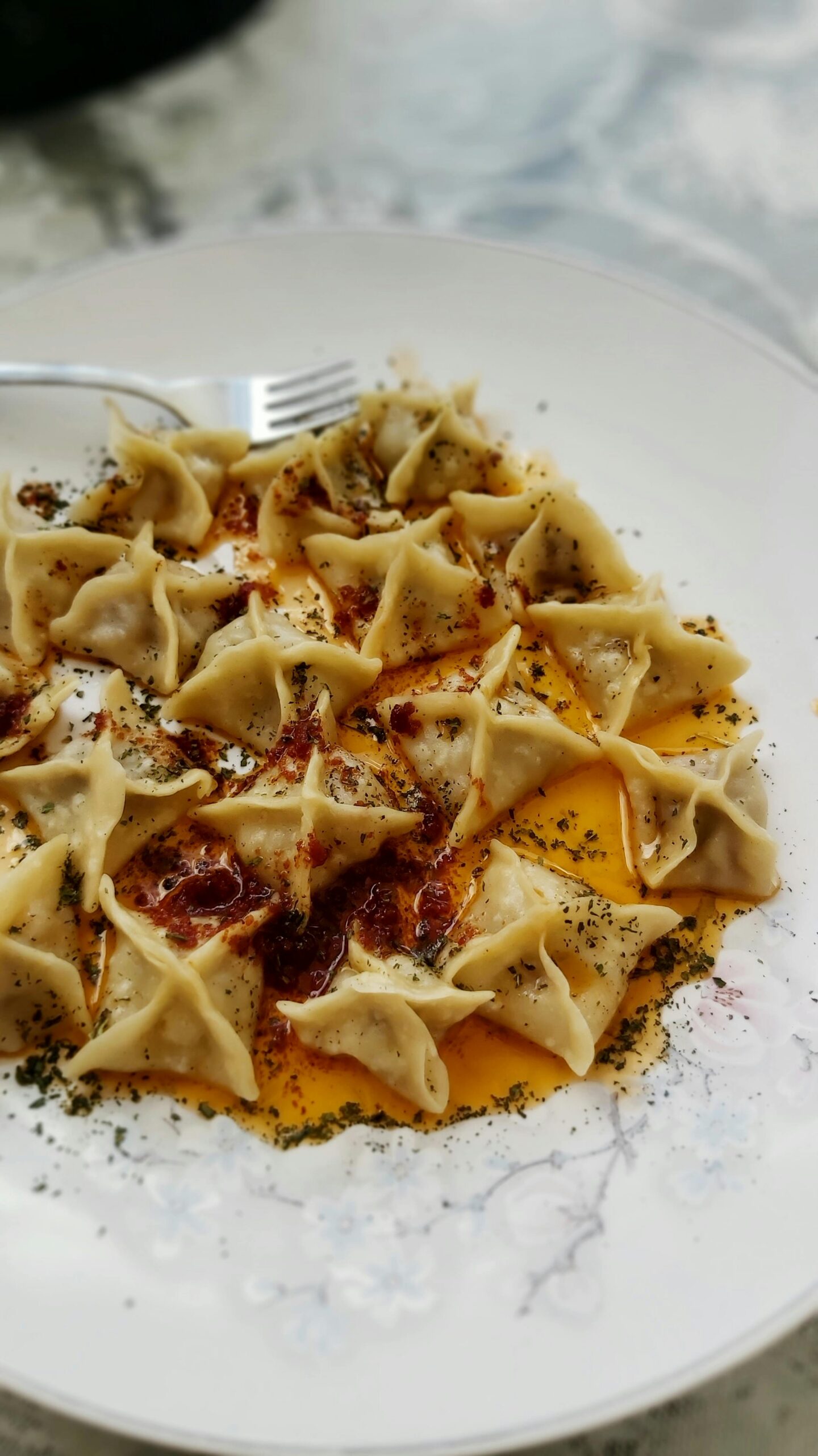 pexels-bi-yasemin-58133527-17243554 - Turkey Family Holidays Manti dumplings on a white plate