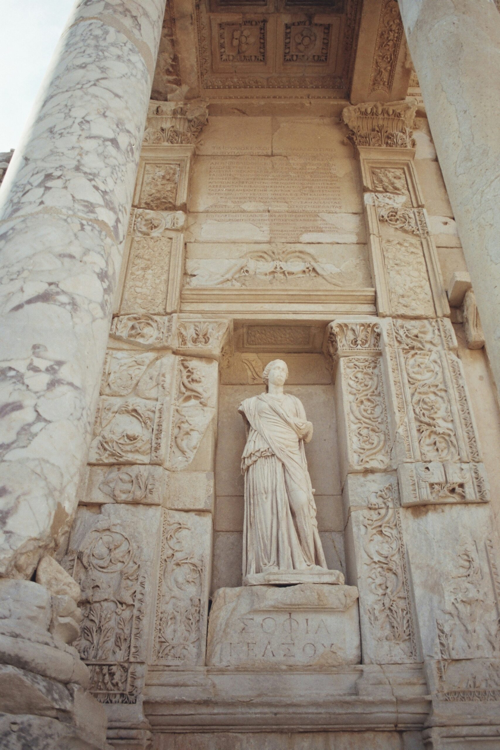 A statue of a woman on the side of a building