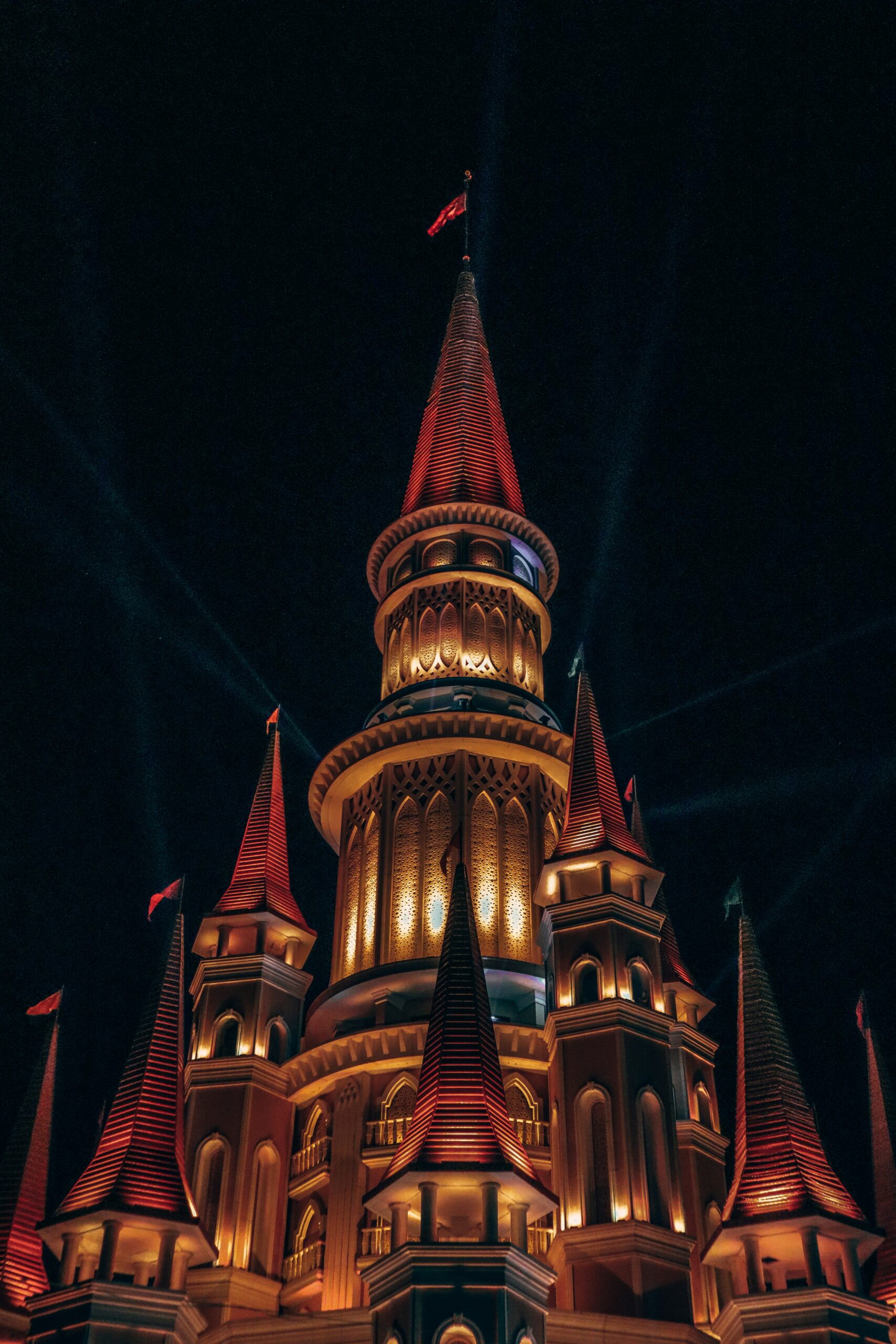 Black and brown colored concrete building during nigh-time in Land of Legends theme park Antalya.
