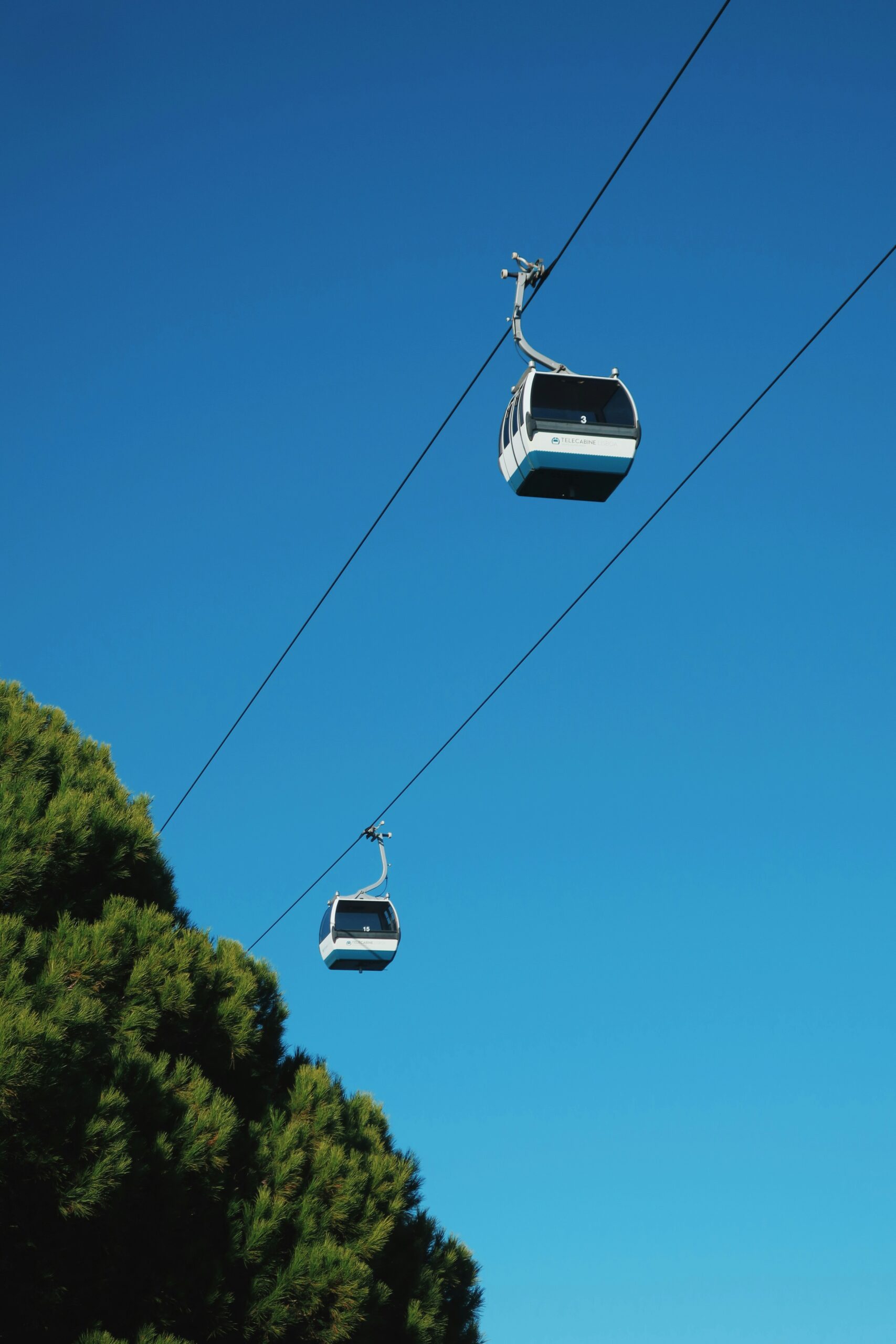 A white cable car under blue sky during daytime