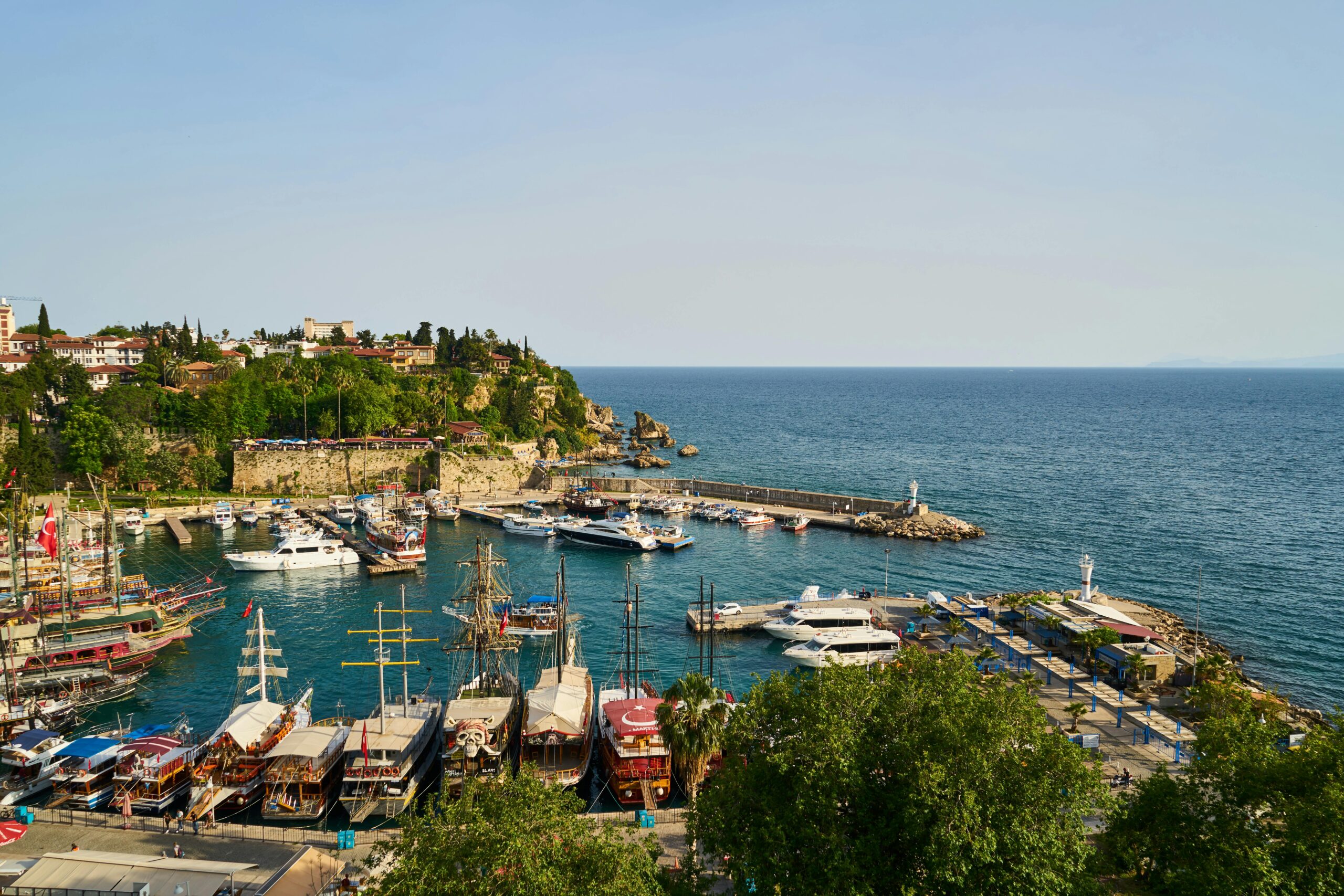 pexels-enginakyurt-2767815 - Turkey Family Holidays View of pile of Assorted-color Boats , Mountains and sea in Antalya.