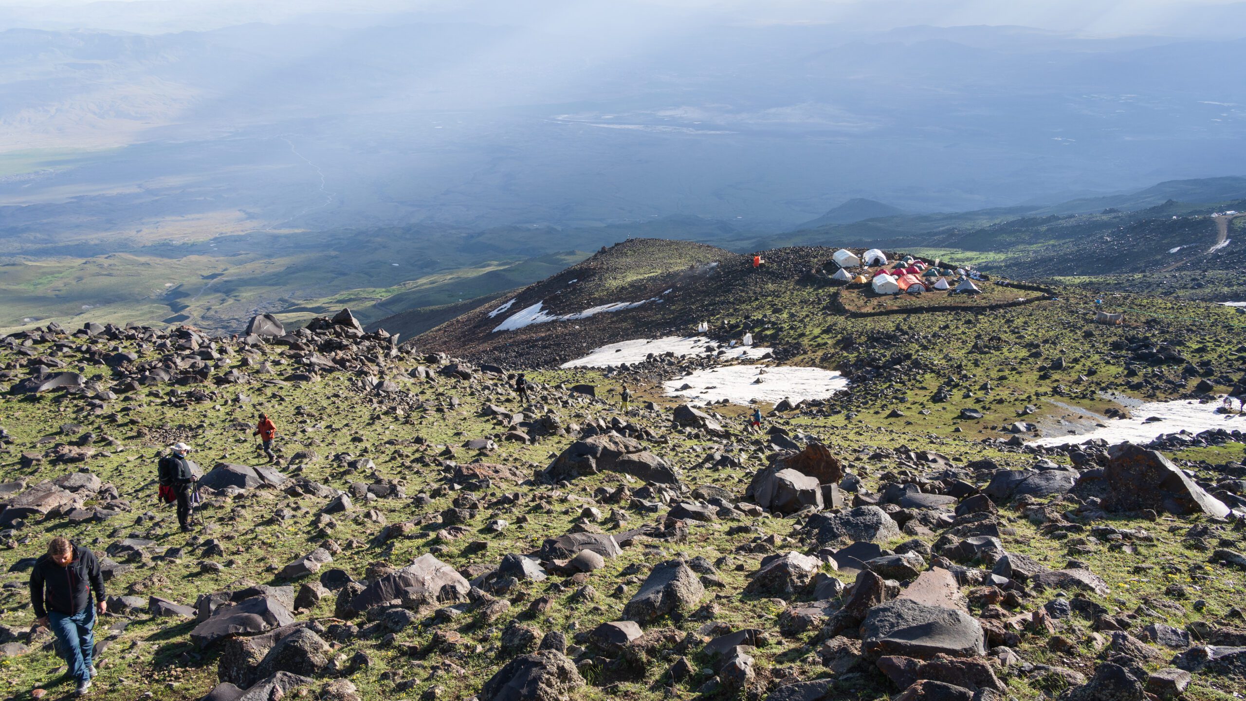 - Turkey Family Holidays Hikers walking away from their camp in alpine landscape, Mount Ararat in Turkey